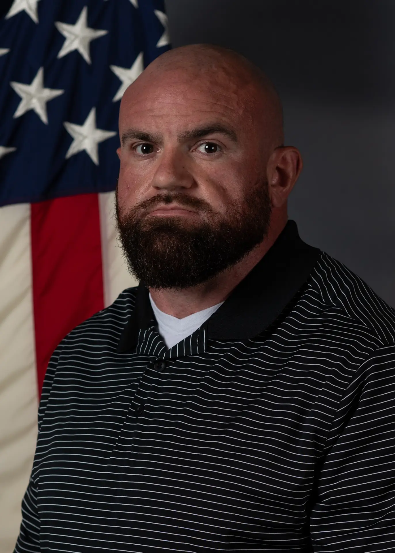 Coach Jordan Betz portrait in front of an American flag